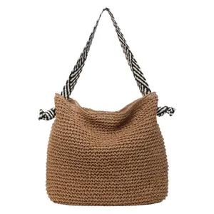 Handcrafted straw shoulder bag with stylish navy and white striped straps for daily wear