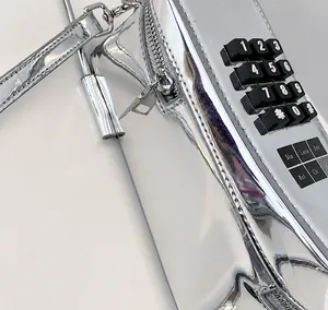 Macro shot of silver metallic crossbody bag featuring a vintage phone keypad design