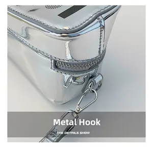 Detail view of the silver metallic bag showing the durable hardware hook and zipper closure