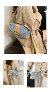 Close-up of retro denim and brown leather patchwork shoulder bag with metal buckle