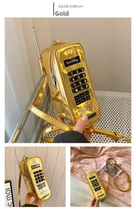 Macro view of retro golden cellphone shaped bag with numerical keypad and antenna details
