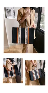 Detail view of Mompick felt tote bag showing handle strap branding and large capacity