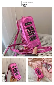 Detailed macro view of retro phone-shaped crossbody bag in glossy rose red finish