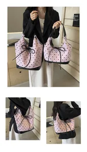 Detailed comparison of large and small pink polka dot tote bags with black ribbon tassels