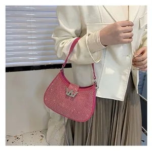 Close-up of pink rhinestone hobo bag with silver chain and metal W buckle detail