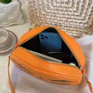 Orange pumpkin crossbody bag with gold zipper and PU leather surface for Halloween