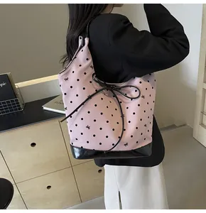Pink polka dot tote bag featuring black bow prints and durable reinforced base