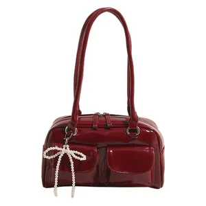 Deep red patent leather underarm bag with double pockets and pearl bow charm accessory