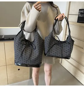 Comparison of large and medium tote bags with bows and leather straps in a lifestyle setting
