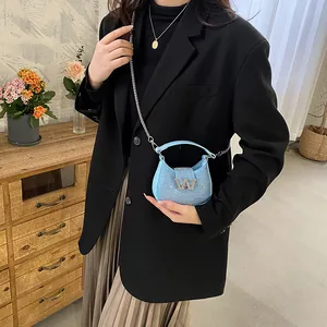 Chic light blue rhinestone mini handbag with silver metal logo and chain strap