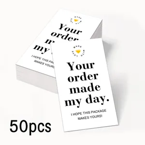 Detail showing stack of 50 white vertical business thank you cards with a yellow heart