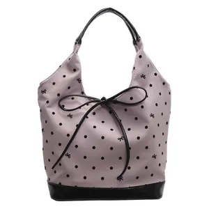 Mauve polka dot tote bag with black bow detail and reinforced handles on white background
