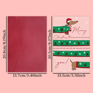 Gros plan d'une drôle de carte de Noël rose avec teckel et enveloppe rouge foncé