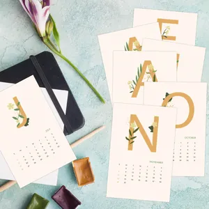 Detailed overhead view of aesthetic 2024 calendar cards with floral letter patterns