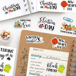 Close-up of assorted holiday planner stickers with handwritten typography on a journal page
