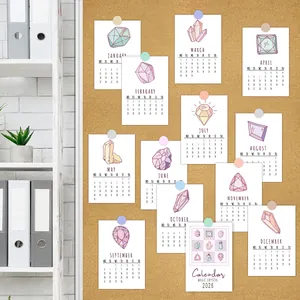 Detailed view of 2026 calendar cards featuring magic crystal illustrations on cork board