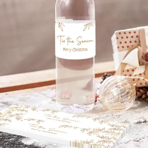 Detail view of festive Merry Christmas water bottle labels with gold floral leaf designs