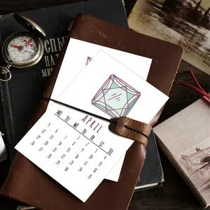 Minimalist April 2026 calendar card with geometric gemstone art in a leather journal