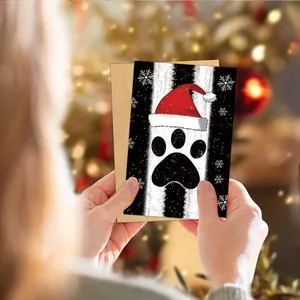 Detailed view of Christmas card featuring a dog paw print with a festive kraft envelope