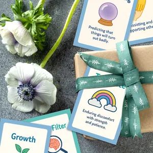 Macro detail of DBT educational flashcards featuring Growth and Patience themes in a gift box