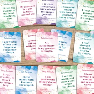 Detail of daily reminder cards with watercolor design and gold foil dots on wood background
