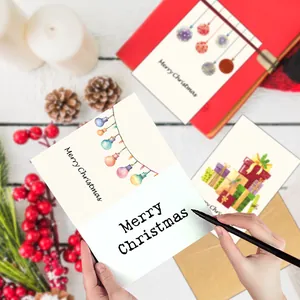 Set of 12 Merry Christmas cards with festive envelopes on a rustic wooden desk