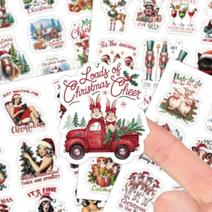 Close-up of vintage Christmas gift stickers showing festive truck and rabbit illustrations