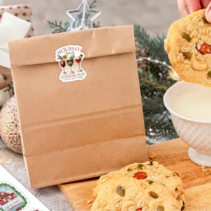 Christmas gift stickers featuring holiday cocktail designs on festive packaging background