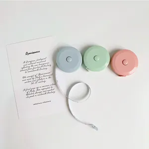 Mini retractable measuring tape in candy colors with rounded design on white background