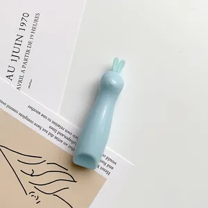Macro detail of cute light blue rabbit-shaped utility knife with smooth finish
