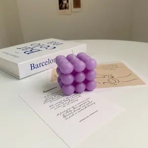 Artistic close-up of a purple cube bubble scented soy candle for home decor styling