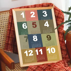 Detail of 2026 calendar poster with minimalist multi-color blocks and wooden frame