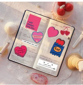 Close-up of pink heart and cherry stickers used for DIY notebook and gift decoration