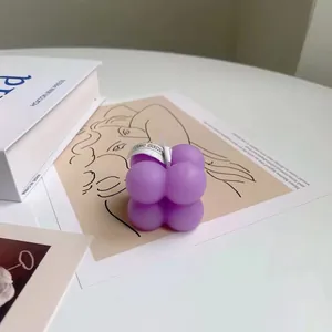 Macro detail of purple cube soybean wax scented candle with a minimalist label on top