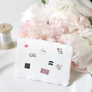 Detail of German wedding stickers featuring romantic roses, red lips and elegant verses