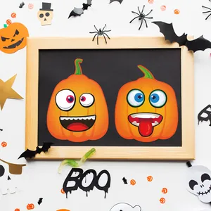 DIY Halloween pumpkin facial expression stickers for kids party decorations on a blackboard