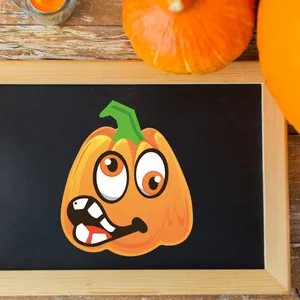 Halloween pumpkin stickers with funny faces displayed on a black board for party decoration