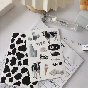 Detailed view of cow print stickers and milk theme decals for stationery journaling