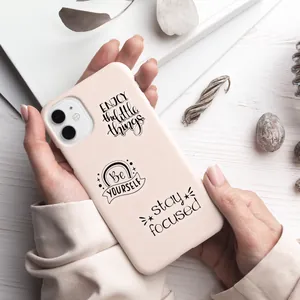 Pale pink silicone iPhone case featuring black handwritten inspirational text on white wood