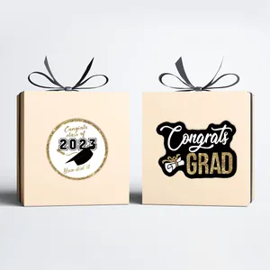 Elegant 2023 graduation gift boxes with black ribbons and Congrats Grad gold lettering