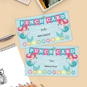 Close-up of mermaid reward punch cards with aquatic elements on a desk with stationery