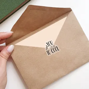 Inspirational clear sticker with YOU are TOO COOL text sealing a kraft envelope