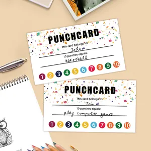 Macro detail of student punch cards with colorful circles and stationery on a beige desk