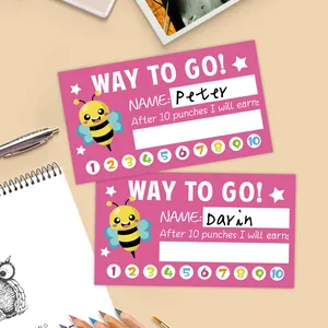 Detail view of pink bee reward punch cards for kids with stationery background