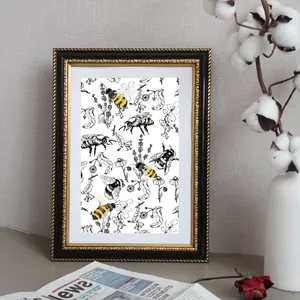 Framed vintage botanical bee sketch with yellow accents in an elegant black and gold frame
