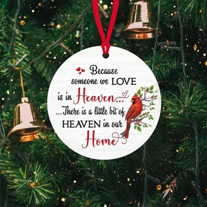 Detailed view of cardinal acrylic ornament hanging on a Christmas tree branch