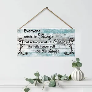 Close-up of rustic rectangular wooden wall sign with humor quote and jute hanging rope