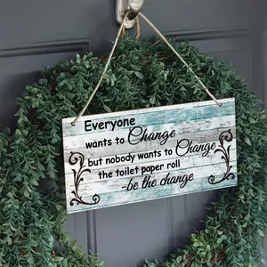 Close-up of rectangular rustic wooden sign with funny quote hanging on a door wreath