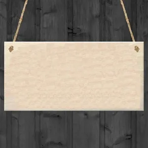 Detail of a rectangular light wood sign with natural grain and jute hanging rope