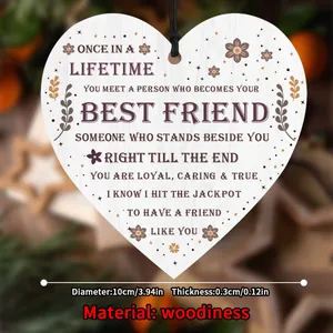 Macro detail of heart-shaped wooden plaque with friendship quote and rustic black string